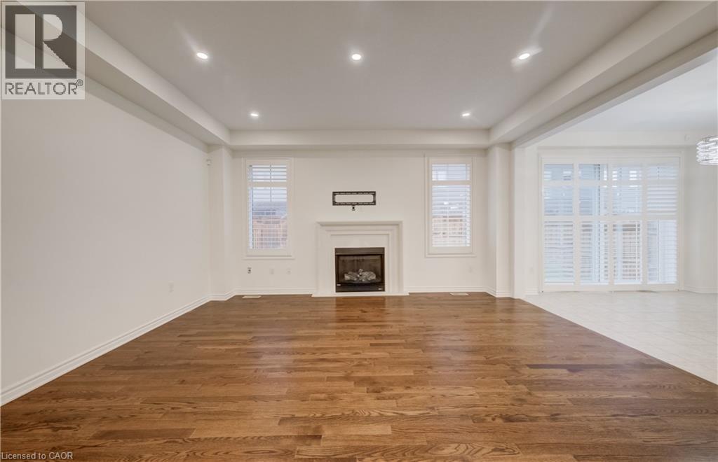 Spacious interior featuring wood-finish flooring and recessed lighting - 52 Pointer Street, Cambridge, ON - Indoor With Fireplace