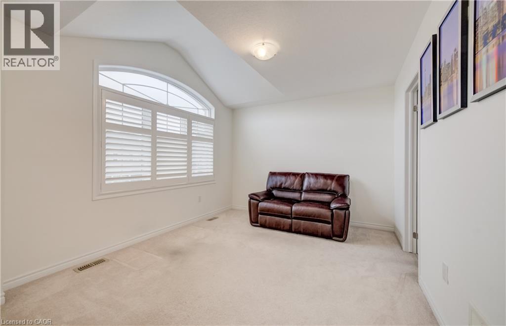 Arch-top window with white plantation shutters - 52 Pointer Street, Cambridge, ON - Indoor Photo Showing Other Room