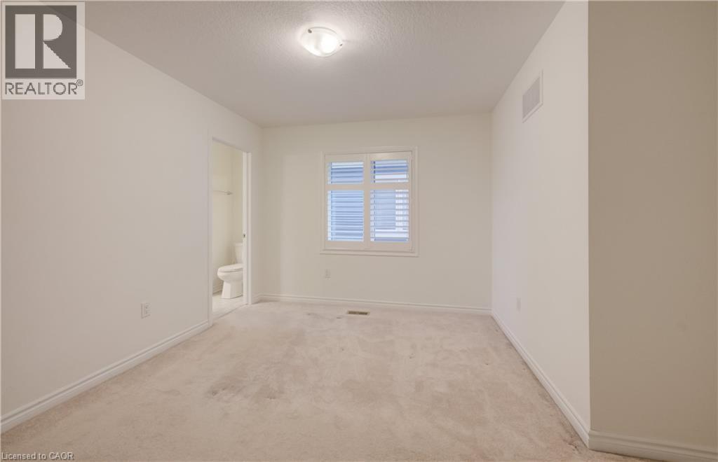 Carpeted room with a window featuring white plantation shutters - 52 Pointer Street, Cambridge, ON - Indoor Photo Showing Other Room