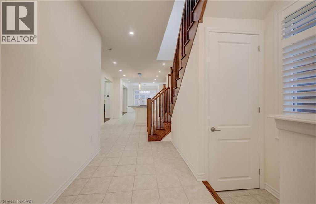 Foyer featuring neutral wall tones, recessed lighting, tile flooring, and a hardwood staircase with traditional balusters - 52 Pointer Street, Cambridge, ON - Indoor Photo Showing Other Room