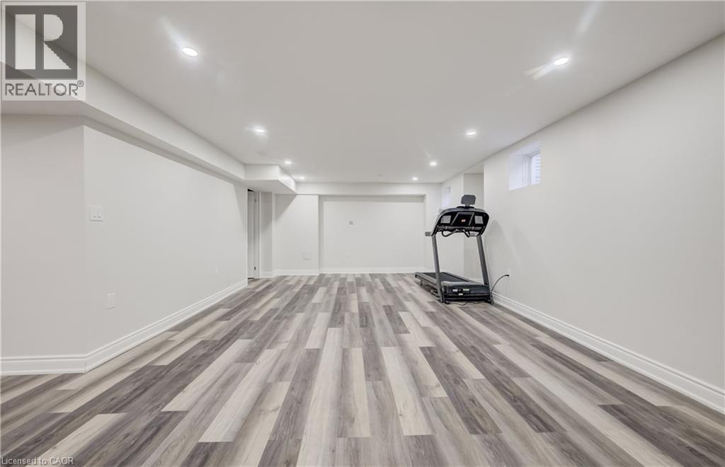 Finished lower level featuring wood-finish flooring, recessed lighting, and bright white walls - 52 Pointer Street, Cambridge, ON - Indoor