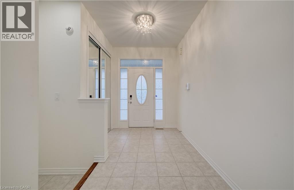 Entryway featuring tile flooring and a decorative semi-flush mount light fixture - 52 Pointer Street, Cambridge, ON - Indoor Photo Showing Other Room