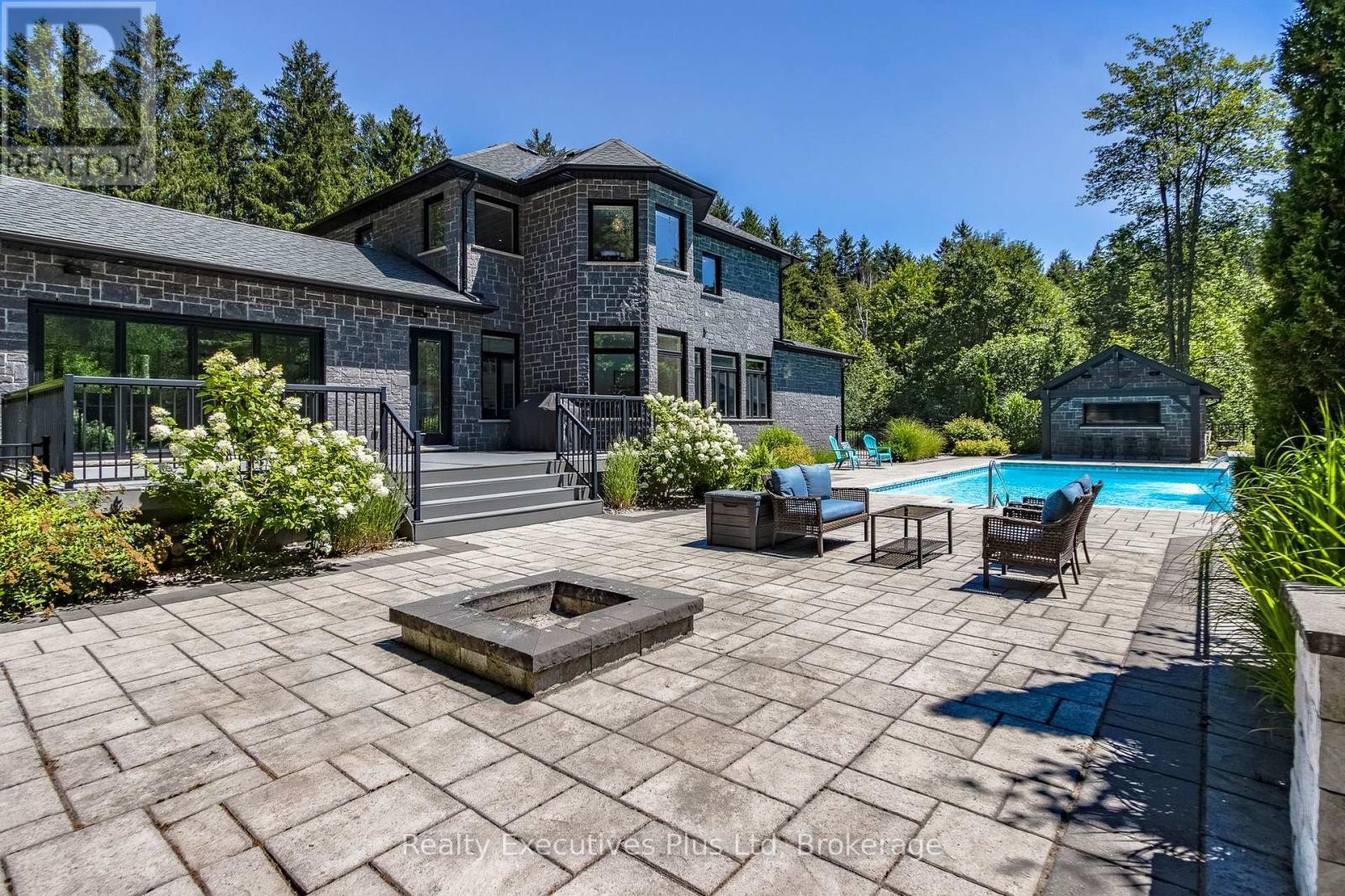 Pool Patio Area with Fireplace - 27 Kingfisher Crescent, Tiny, ON - Outdoor With In Ground Pool With Deck Patio Veranda