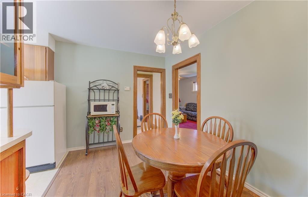Functional dining area featuring wood-finish flooring, and a classic chandelier - 224 Weber Street E, Kitchener, ON - Indoor Photo Showing Dining Room