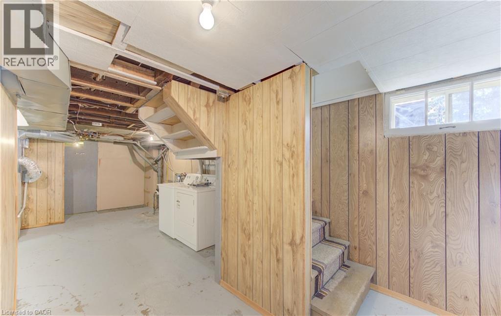 Utility space featuring wood-finish paneling, and a partial drop ceiling - 224 Weber Street E, Kitchener, ON - Indoor Photo Showing Laundry Room