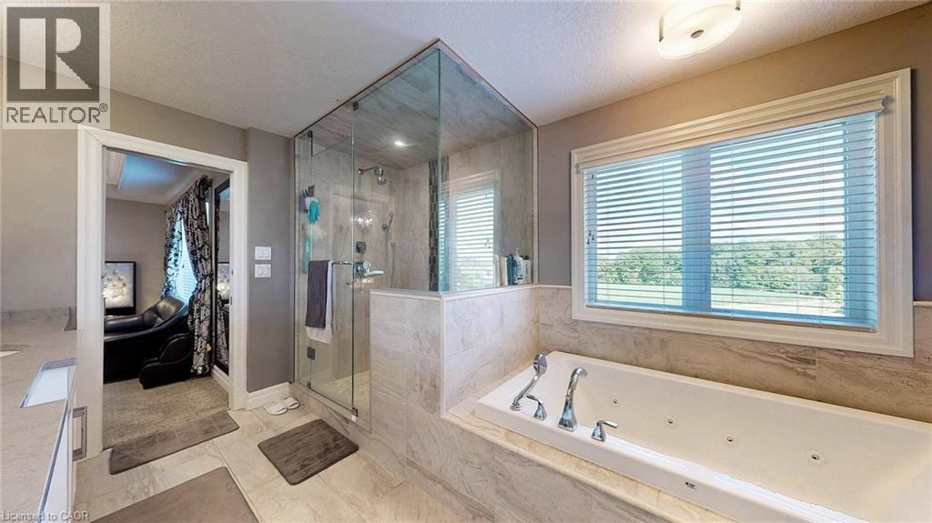 Bathroom featuring a built-in jetted tub, a glass-enclosed shower, and a large window with horizontal blinds - 537 Millstream Drive, Waterloo, ON - Indoor Photo Showing Bathroom