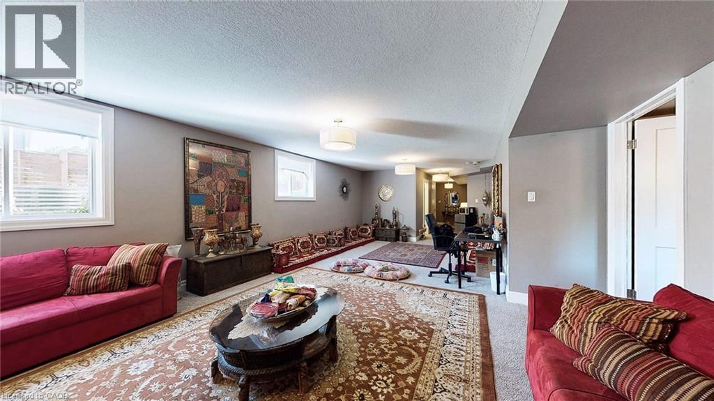 Spacious room with light gray walls, white trim, and recessed lighting - 537 Millstream Drive, Waterloo, ON - Indoor Photo Showing Living Room