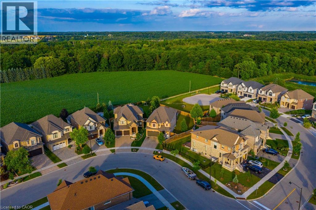 Aerial perspective showcasing a residential community with varied architectural styles and stone or siding exteriors - 537 Millstream Drive, Waterloo, ON - Outdoor With View