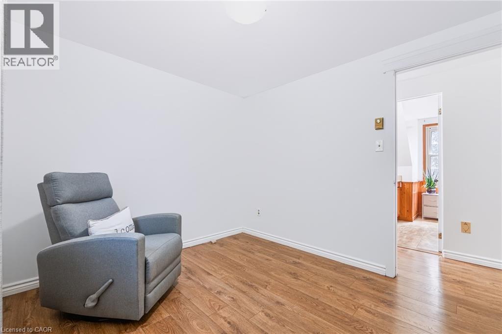 Room featuring wood-finish flooring, white baseboards, and a neutral wall palette - 34 Peachtree Crescent, Cambridge, ON - Indoor