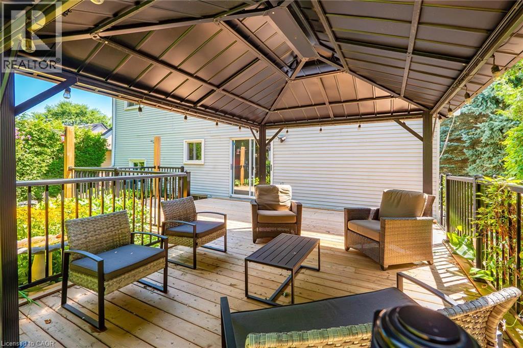 Expansive wood-finish deck featuring a permanent gazebo with integrated lighting - 34 Peachtree Crescent, Cambridge, ON - Outdoor With Deck Patio Veranda With Exterior