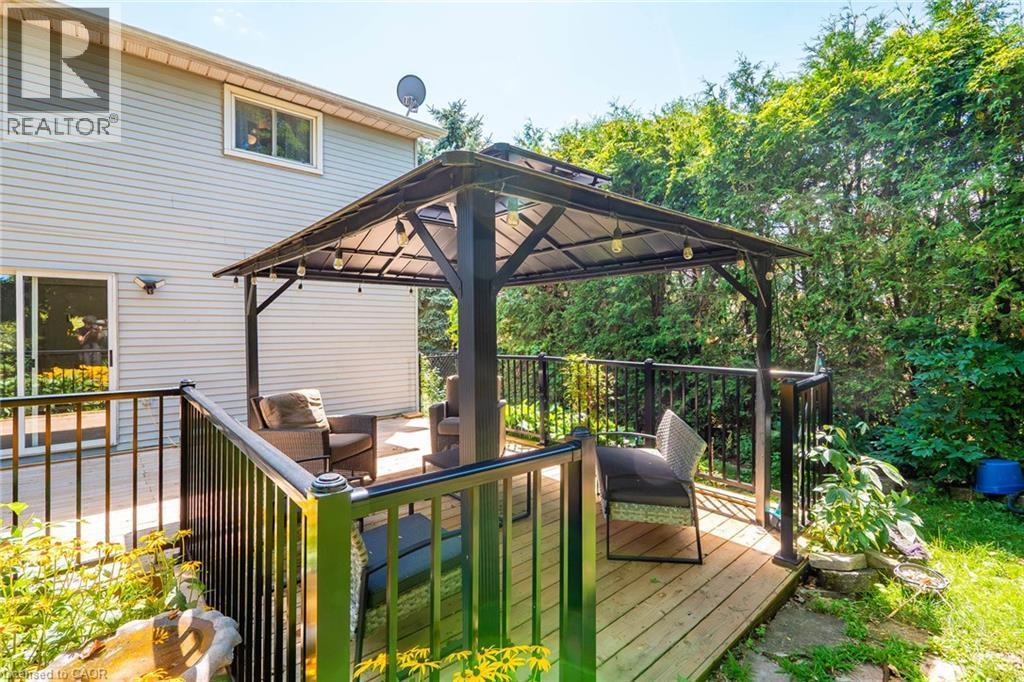 Spacious wooden deck featuring a metal-frame gazebo with integrated lighting - 34 Peachtree Crescent, Cambridge, ON - Outdoor With Deck Patio Veranda With Exterior