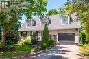 Exterior featuring a combination of light-colored stone and horizontal siding, a dark gray shingle roof, and three prominent dormer windows - 34 Peachtree Crescent, Cambridge, ON  - Outdoor With Facade 