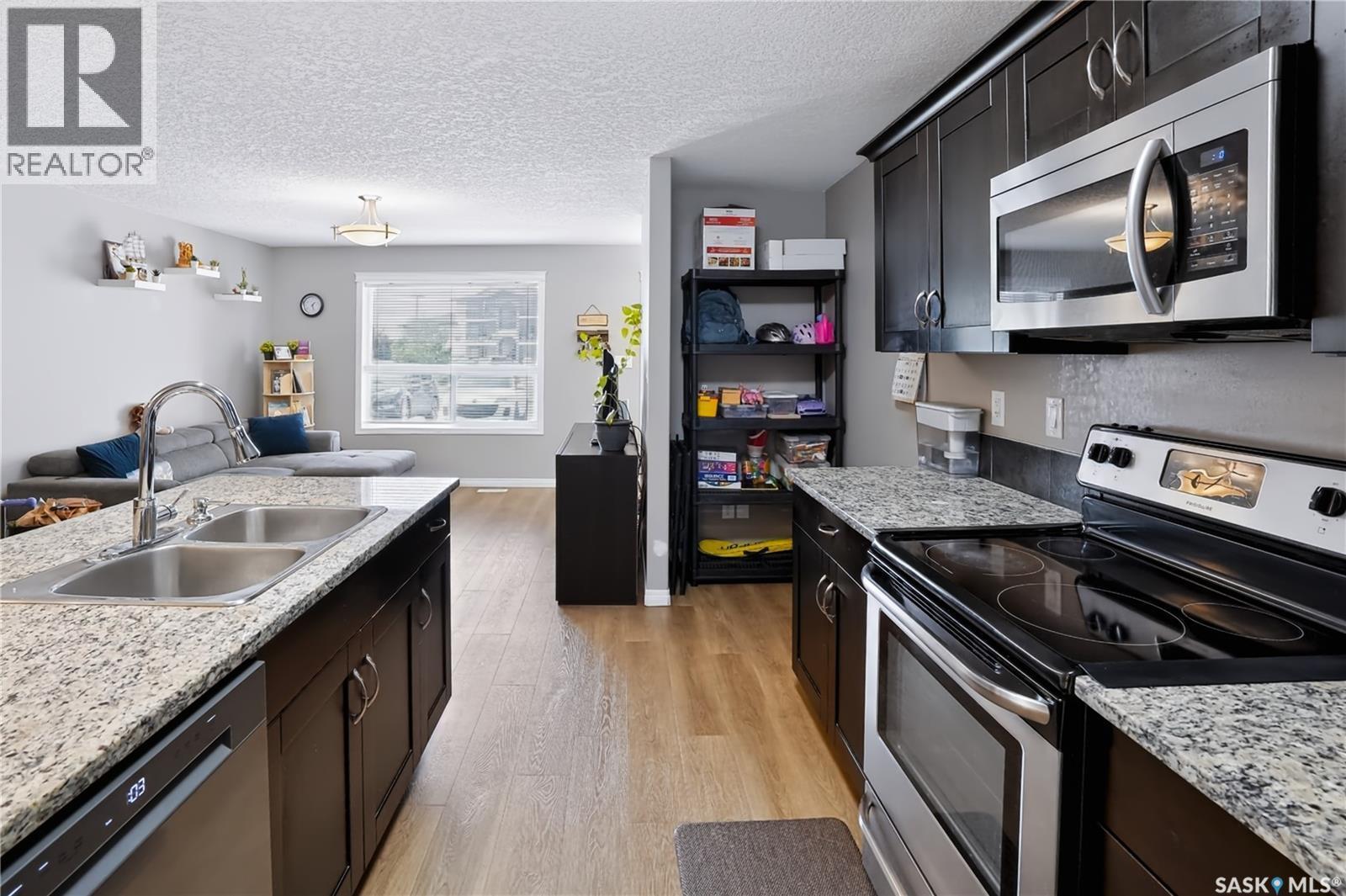 113 125 Willis Crescent, Saskatoon, SK - Indoor Photo Showing Kitchen With Double Sink