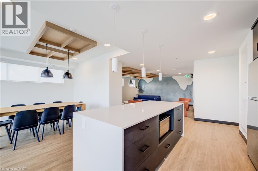 Spacious open-concept area featuring wood-finish flooring throughout - 1333 Weber Street E Unit# 708, Kitchener, ON - Indoor