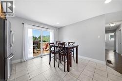 Bright dining area with light tile flooring and recessed lighting - 