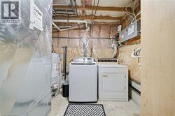 Dedicated utility area featuring a washer, dryer, and water heater - 