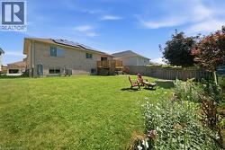 Expansive green lawn with a full privacy fence - 