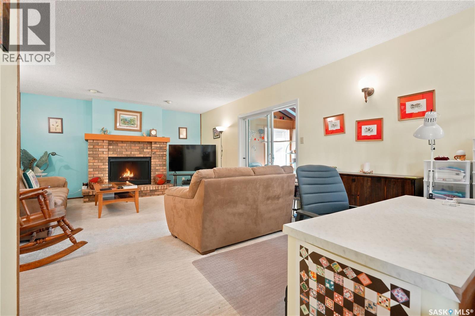 522 Delaronde Road, Saskatoon, SK - Indoor Photo Showing Living Room With Fireplace
