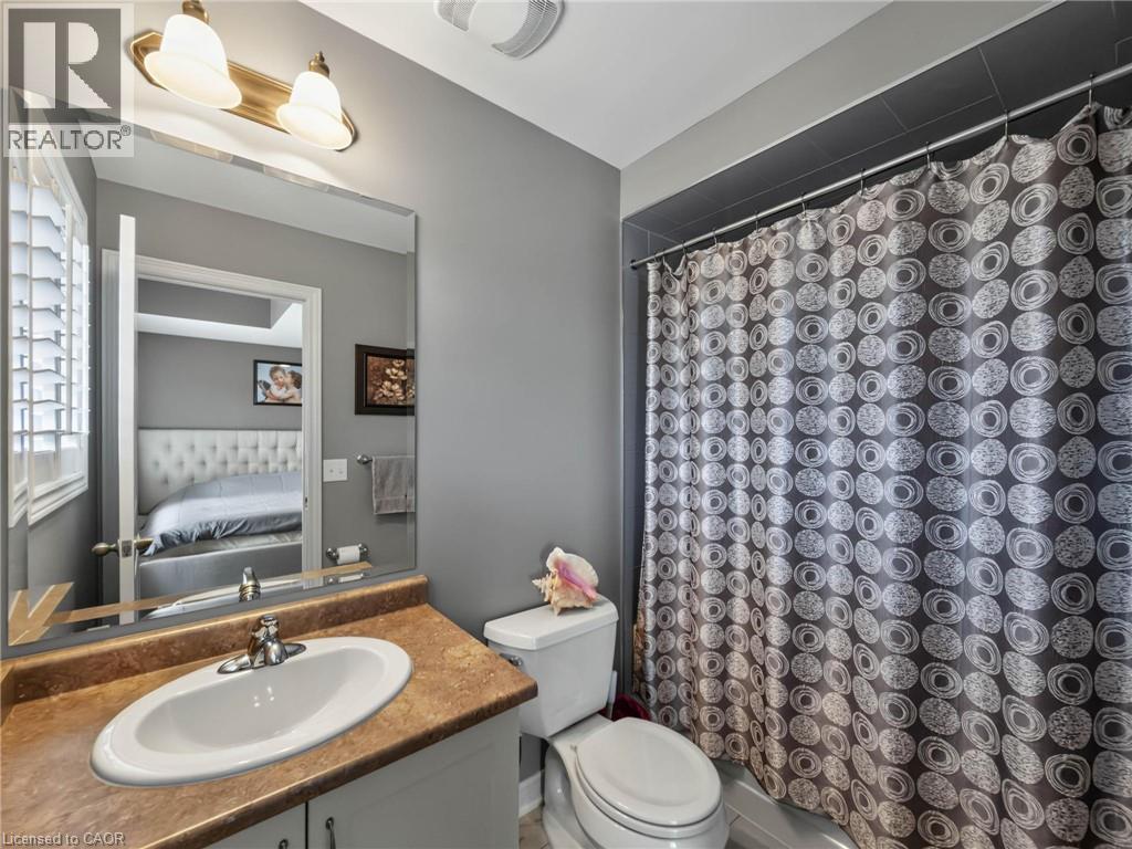 Bathroom vanity with an oval sink and a brown-toned countertop - 80 Sutherland Crescent, Ancaster, ON - Indoor Photo Showing Bathroom