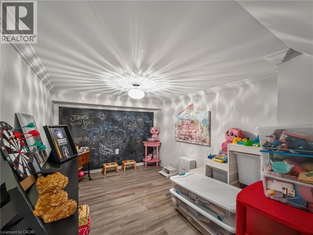 Versatile room featuring crown molding, a built-in chalkboard wall, wood-finish flooring, and recessed ceiling lighting - 80 Sutherland Crescent, Ancaster, ON - Indoor Photo Showing Other Room
