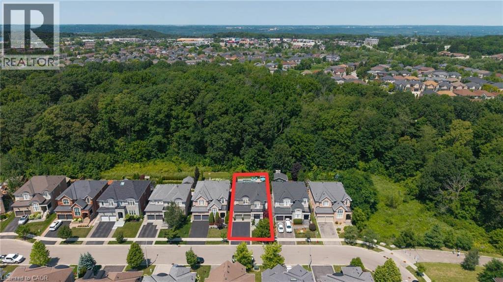Contemporary residential property featuring a gray facade, dark roof, and an attached garage - 80 Sutherland Crescent, Ancaster, ON - Outdoor With View