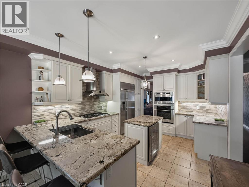 Kitchen featuring granite countertops, stainless steel appliances, white cabinetry, a tiled backsplash, and recessed lighting - 80 Sutherland Crescent, Ancaster, ON - Indoor Photo Showing Kitchen With Upgraded Kitchen
