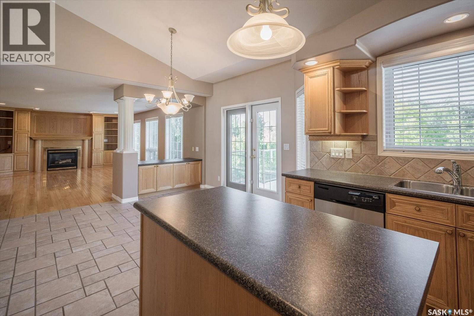 226 Horlick Crescent, Saskatoon, SK - Indoor Photo Showing Kitchen With Fireplace With Double Sink