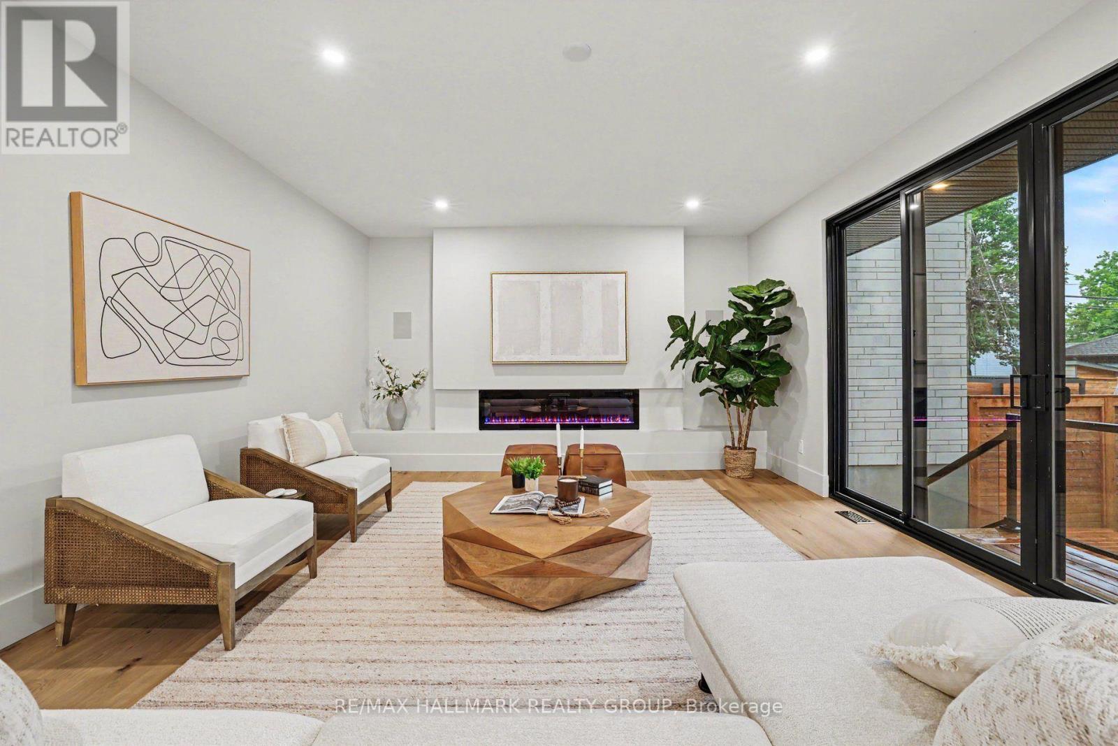 Floor to ceiling fireplace. - 218 Woodland Avenue, Ottawa, ON - Indoor Photo Showing Other Room