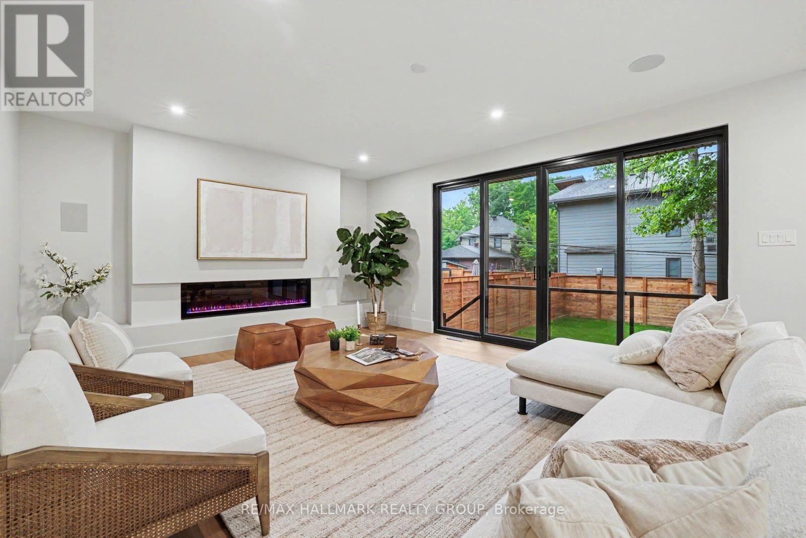 Double patio doors leads out to 2 tier deck. - 218 Woodland Avenue, Ottawa, ON - Indoor Photo Showing Living Room