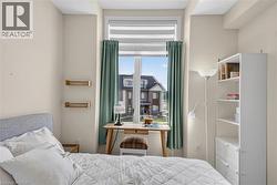 Bright window featuring roller shades and drapery panels - 
