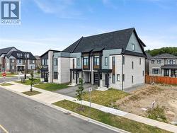 Modern architectural design featuring a striking two-story residence with a steeply pitched gable roof and contrasting light-colored exterior cladding - 
