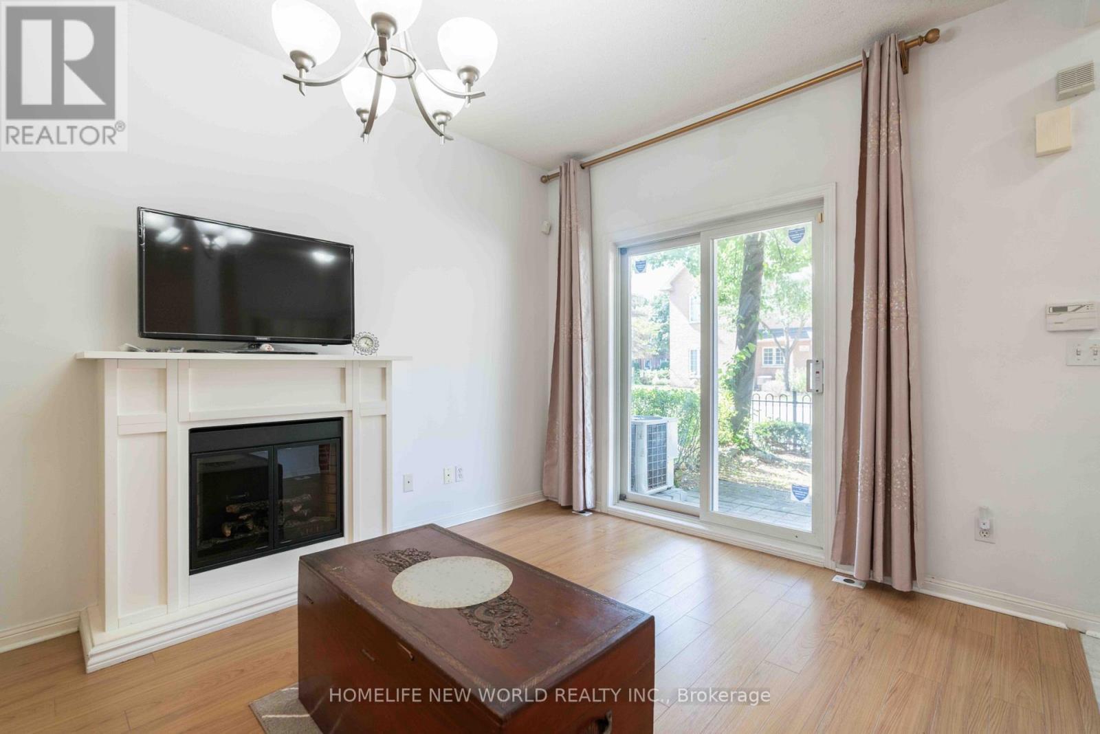 12 - 21 St. Moritz Way, Markham, ON - Indoor Photo Showing Living Room With Fireplace