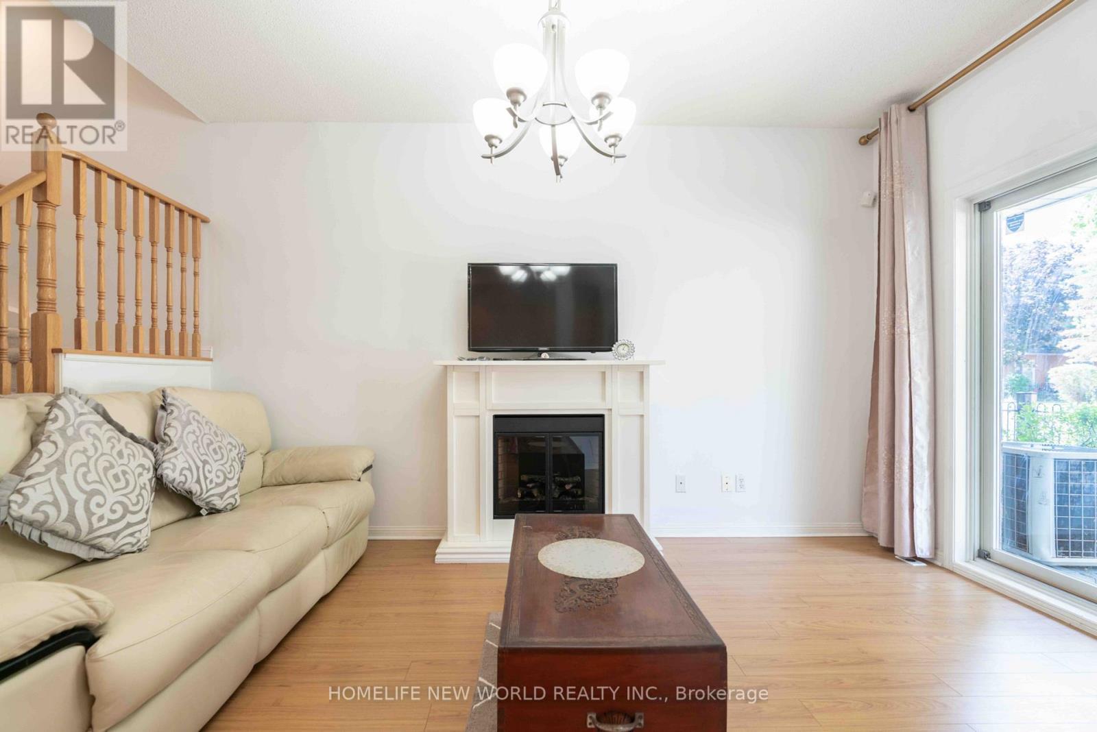 12 - 21 St. Moritz Way, Markham, ON - Indoor Photo Showing Living Room With Fireplace