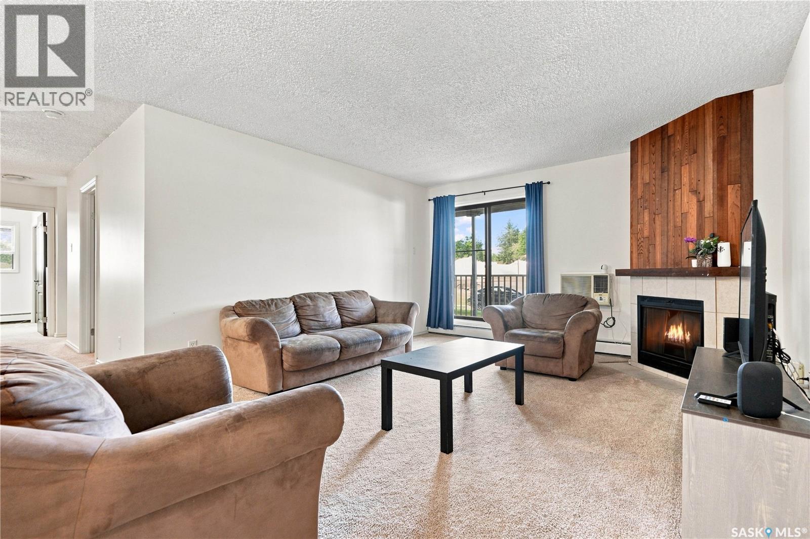 108G 1121 Mckercher Drive, Saskatoon, SK - Indoor Photo Showing Living Room With Fireplace