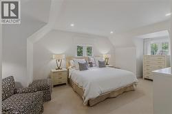 Bedroom featuring neutral carpeting and white wall finishes - 
