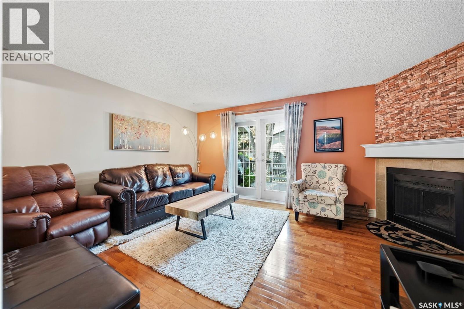 402 2703 Spadina Crescent E, Saskatoon, SK - Indoor Photo Showing Living Room With Fireplace