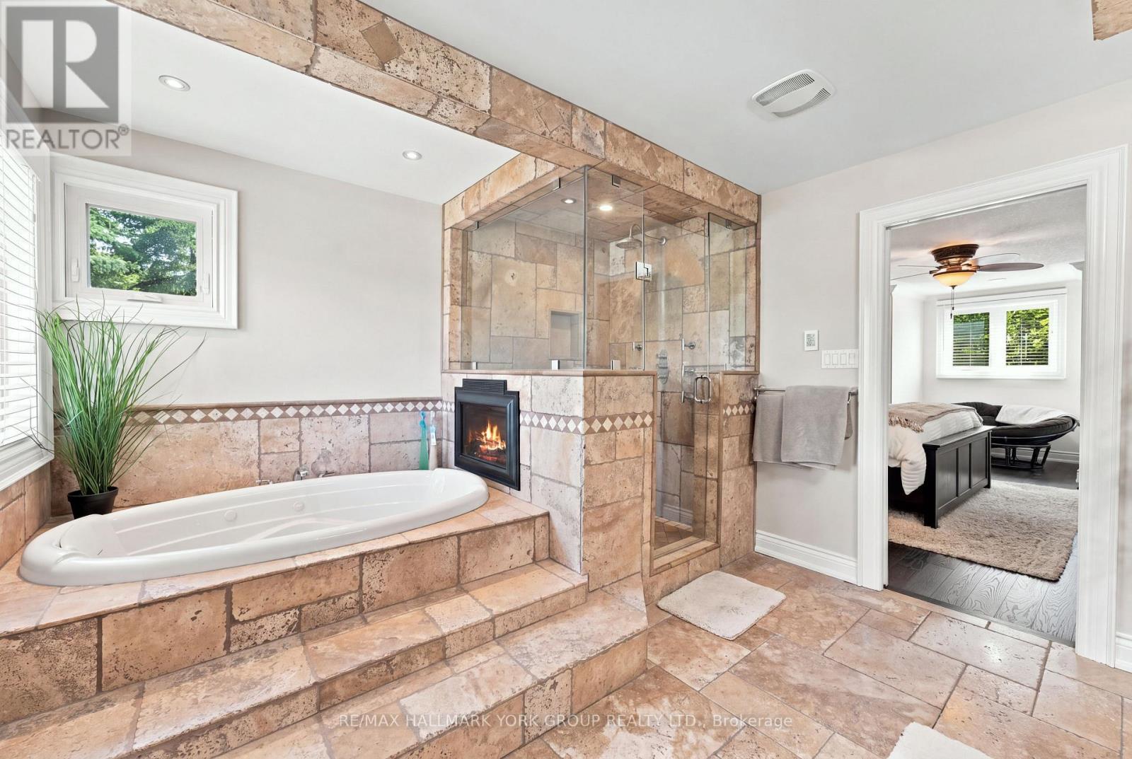 Large jacuzzi soaker tub with fireplace - 111 Whispering Pine Trail, Aurora, ON - Indoor Photo Showing Bathroom