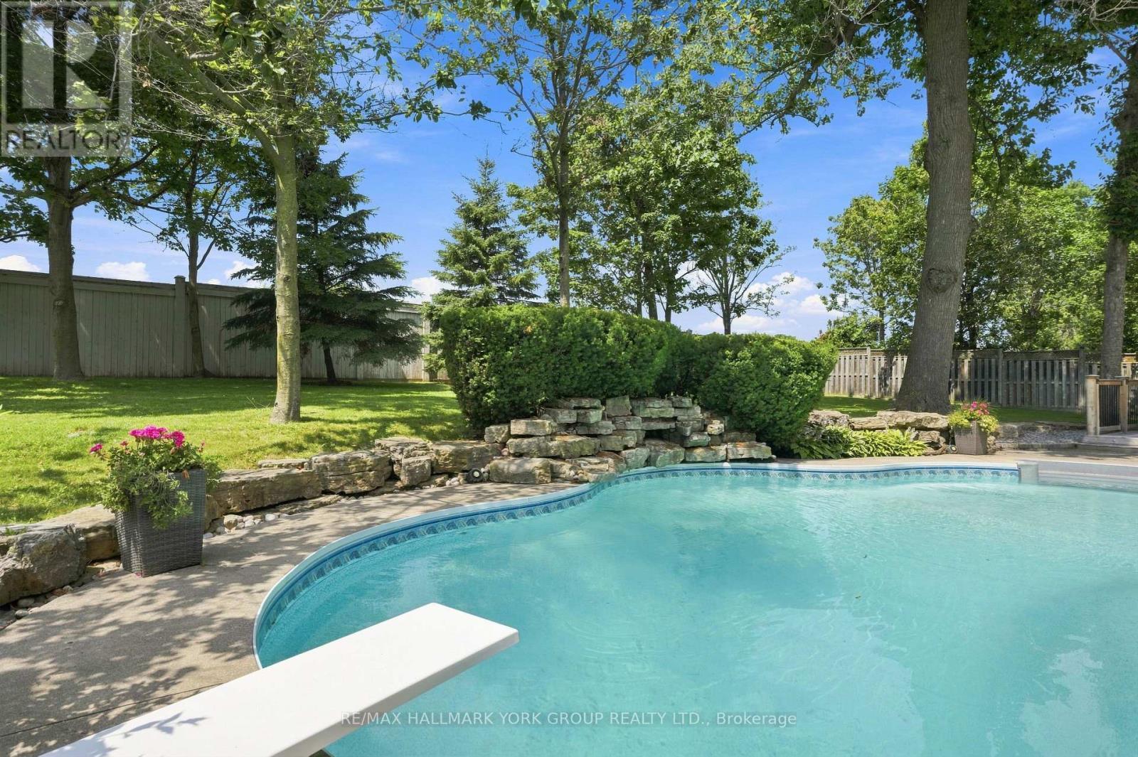 Pool with Diving board - 111 Whispering Pine Trail, Aurora, ON - Outdoor With In Ground Pool With Backyard