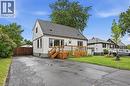 White siding residence with a dark shingle roof and contrasting dark trim - 450 East 42Nd Street, Hamilton, ON  - Outdoor With Above Ground Pool 