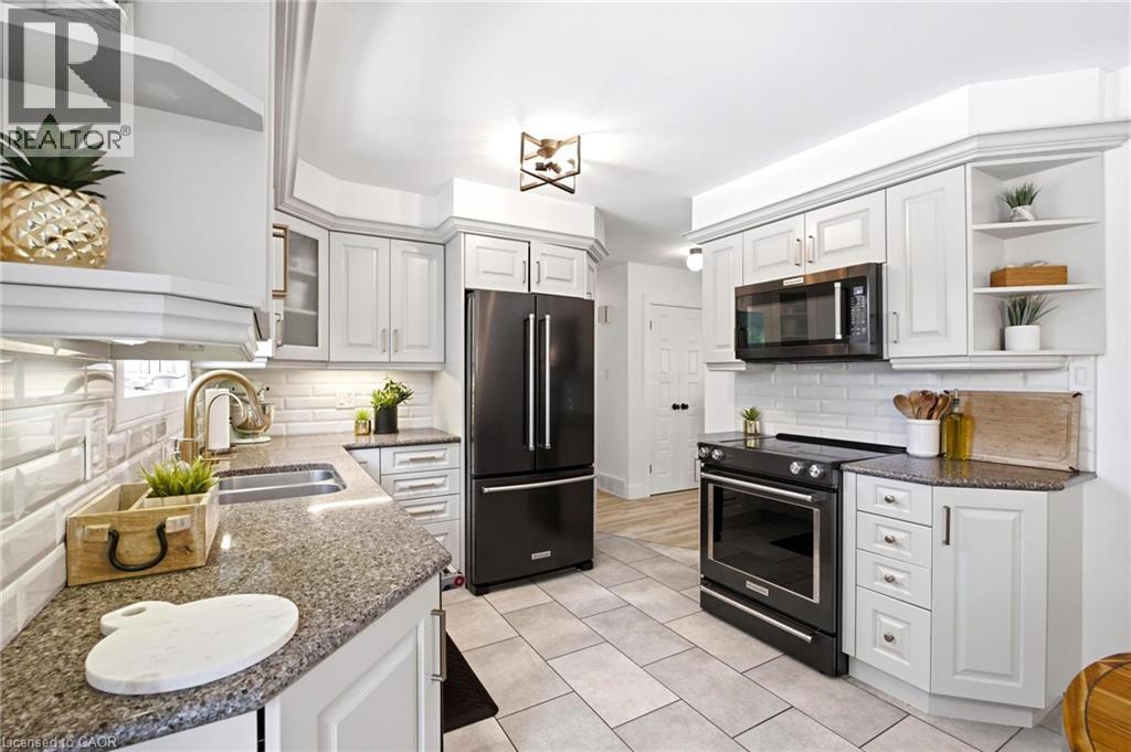 including a refrigerator, range, and microwave - 581 Glendene Crescent, Waterloo, ON - Indoor Photo Showing Kitchen With Double Sink With Upgraded Kitchen