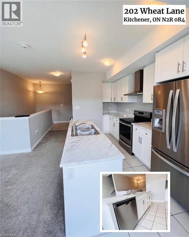Modern kitchen featuring white cabinetry, stainless steel appliances including a built-in oven and refrigerator, marble-look countertops, pendant lighting, and an oversized island - 202 Wheat Lane, Kitchener, ON - Indoor Photo Showing Kitchen With Double Sink