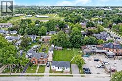 Aerial perspective showcasing a residential street with mature trees and established properties - 