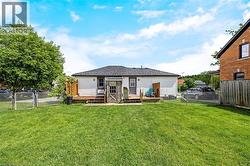 Charming ranch-style home with a spacious, level lawn and mature landscaping - 