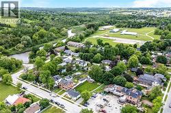 Aerial view showcasing this established residential property nestled within lush, mature landscaping - 