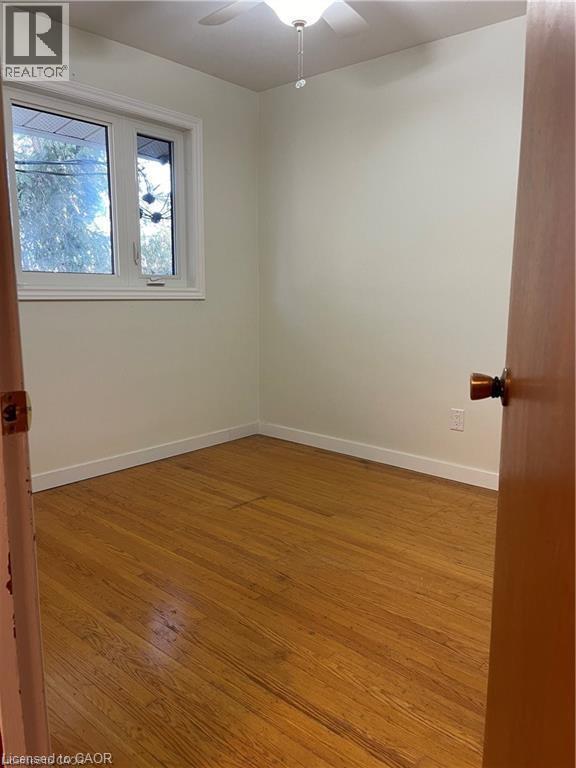 Hardwood flooring throughout this room features a white baseboard trim - 683 Coronation Boulevard Unit# 2, Cambridge, ON - Indoor Photo Showing Other Room