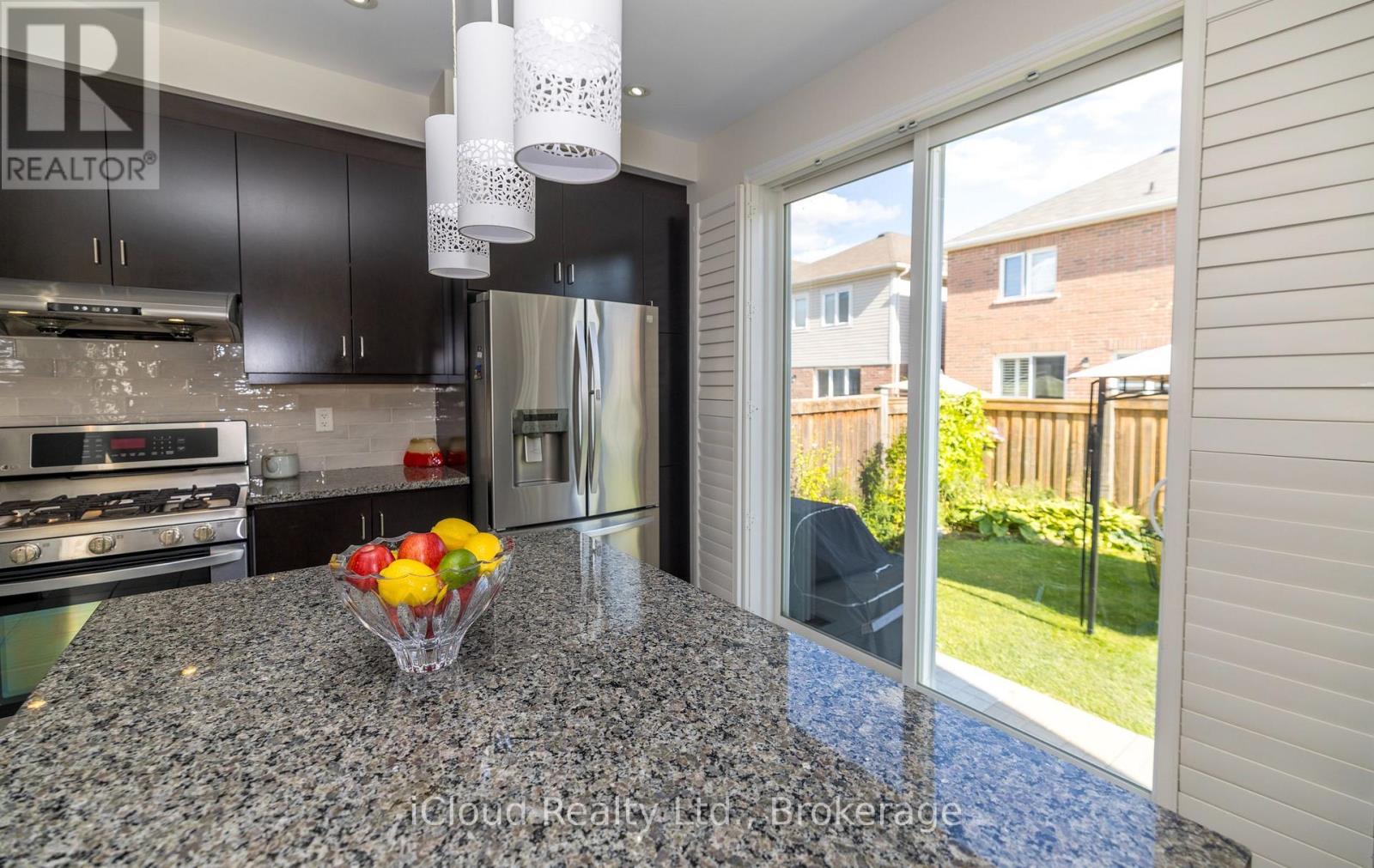 Kitchen Overlooks Backyard - 954 Penson Crescent, Milton, ON - Indoor Photo Showing Kitchen With Stainless Steel Kitchen