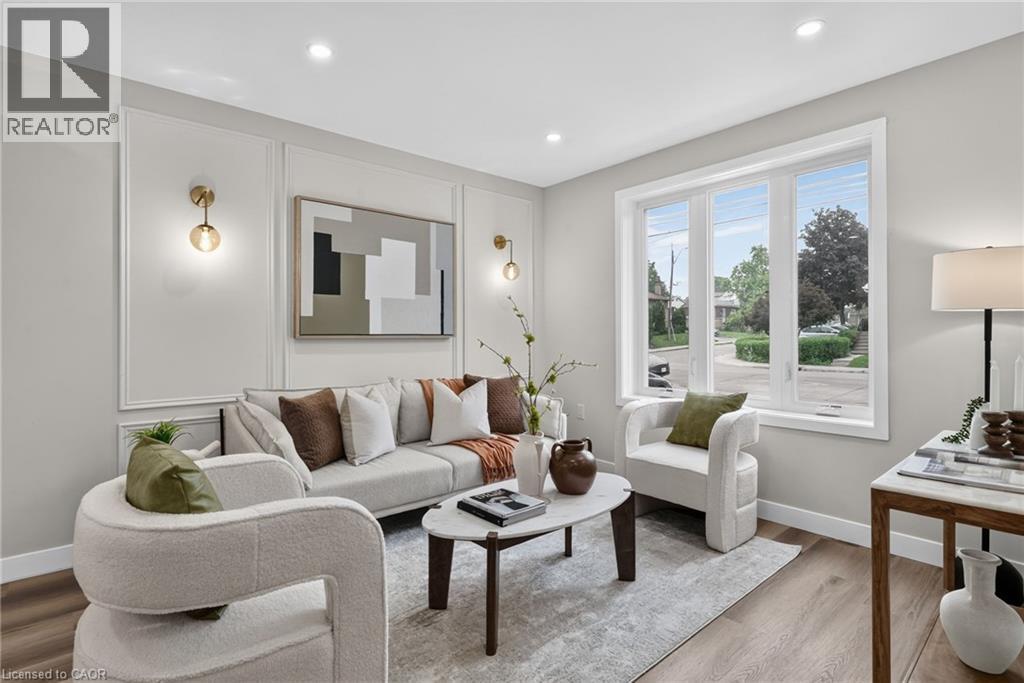 Bright living space featuring recessed lighting and wood-finish flooring - 325 Queensdale Avenue E, Hamilton, ON - Indoor Photo Showing Living Room