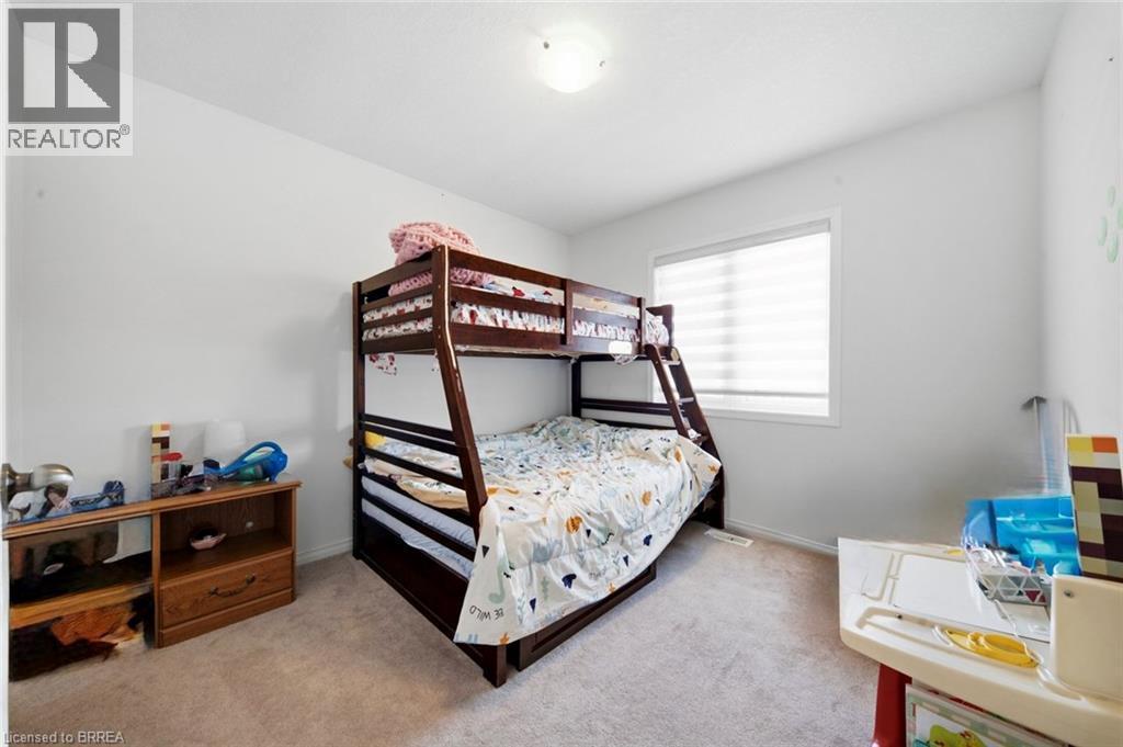 Carpeted room featuring a single window with blinds, white walls, and a ceiling-mounted light fixture - 32 Cole Crescent, Brantford, ON - Indoor Photo Showing Bedroom
