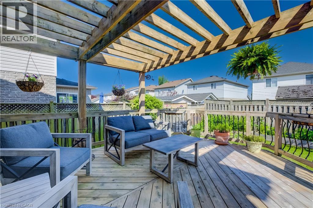 Expansive wood-finish deck with a large wooden pergola, perimeter fencing, and a decorative railing - 496 Langlaw Drive, Cambridge, ON - Outdoor With Deck Patio Veranda With Exterior