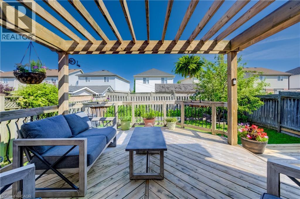 Expansive outdoor deck featuring wood flooring and a slatted pergola overhead - 496 Langlaw Drive, Cambridge, ON - Outdoor With Deck Patio Veranda